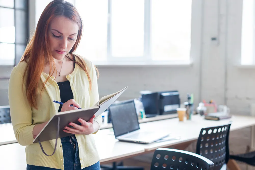 Professional holding a clipboard in an office